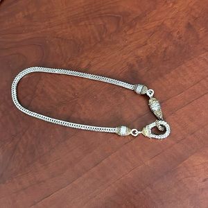 Silver tone thick necklace with two tone hook clasp.